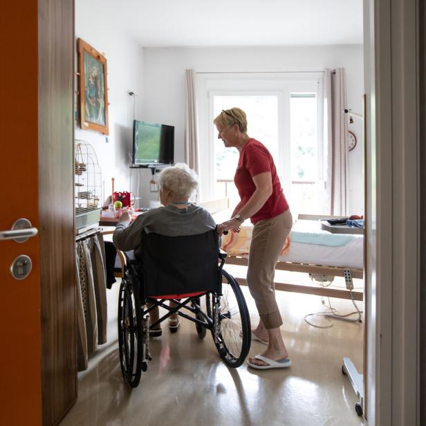 Caregiver and a senior woman in a wheelchair