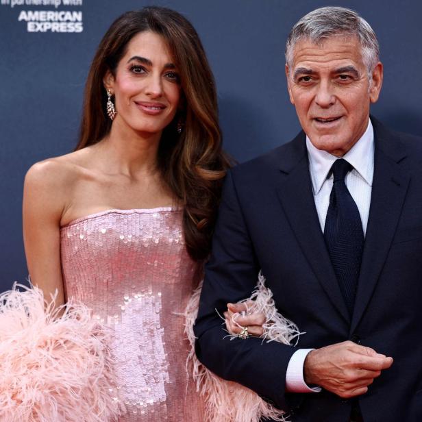 Amal und George Clooney schön gekleidet bei einem Event.