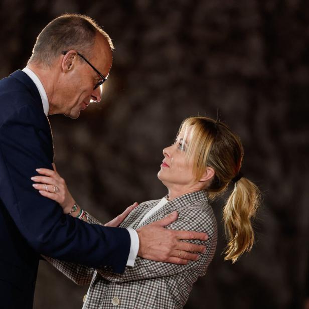 Friedrich Merz legt Giorgia Meloni die Hände auf die Schultern.