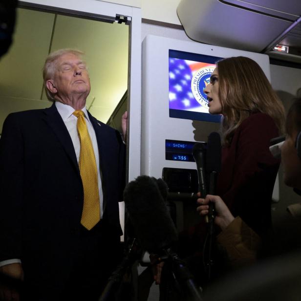 U.S. President Trump speaks to reporters aboard Air Force One en route to Joint Base Andrews