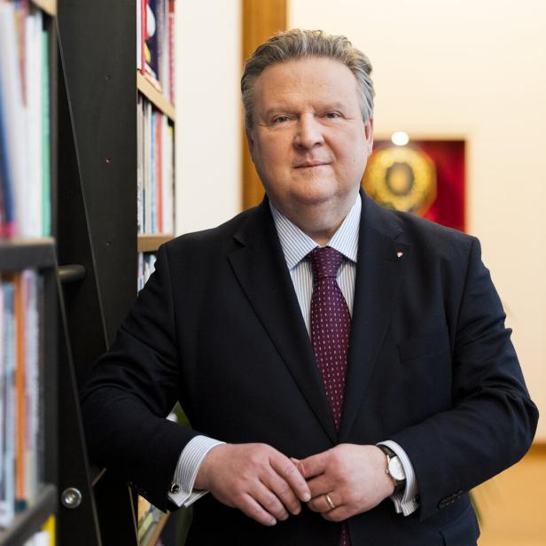 Michael Ludwig im Anzug steht vor einem Bücherregal.