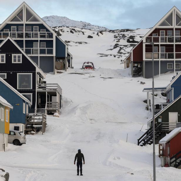 A man stands on a street on the day of the meeting between top U.S. officials and the foreign ministers of Denmark and Greenland, in Nuuk
