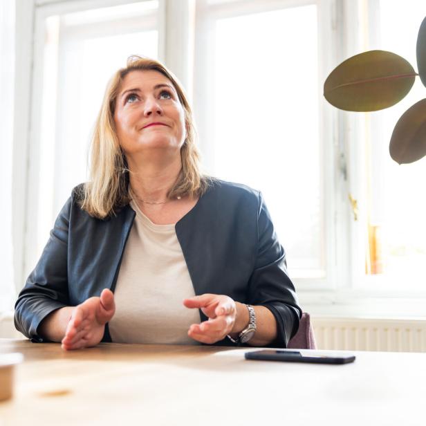 Bettina Emmerling von den Neos sitzt in ihrem. Büro an einem Schreibtisch.