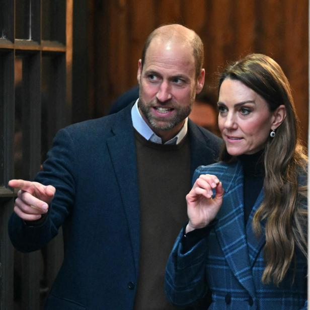 Prinz William zeigt mit dem Finger, während Kate Middleton daneben steht.