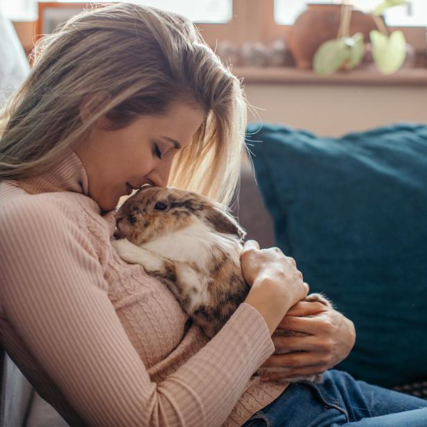 Beautiful young woman and her bunny pet