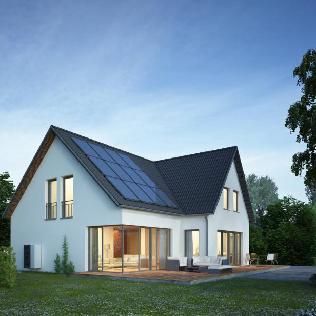 Modern house in the evening with electric heat pump