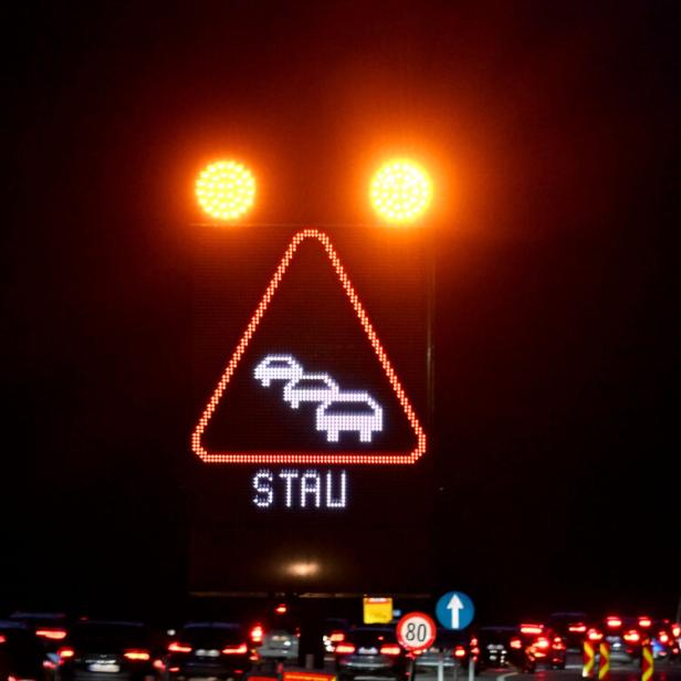 Ein Schild mit der Aufschrift "Stau" im Nachtverkehr