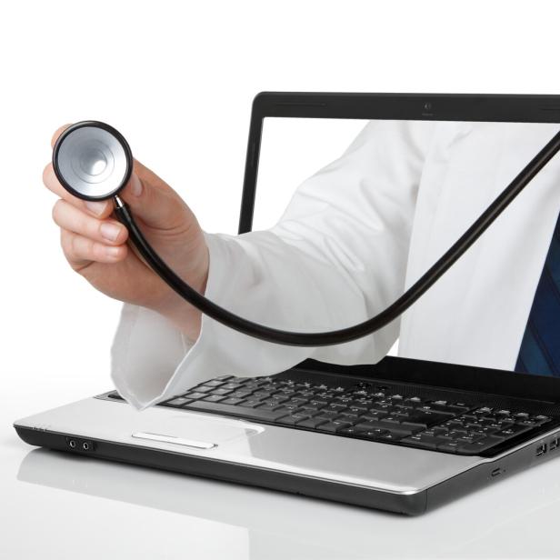 Ein Stethoskop kommt aus einem Laptop-Bildschirm.