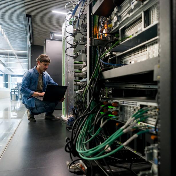 Computer technician fixing a network server at the office