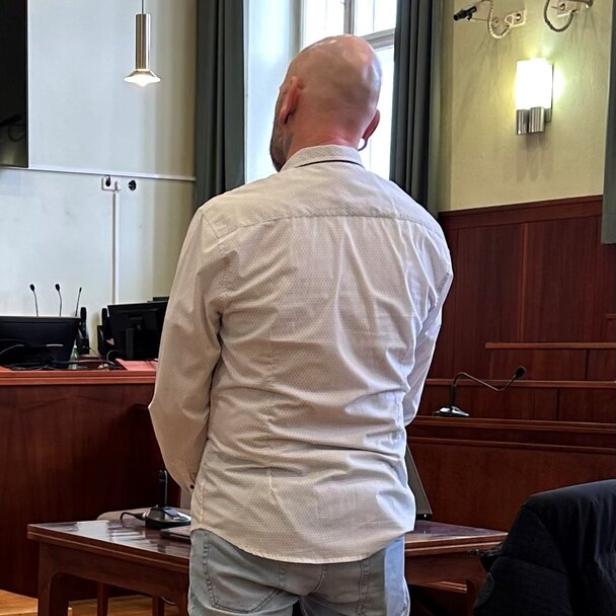 Ein Angeklagter im Gerichtssaal von hinten