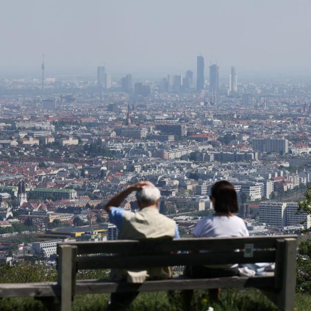 People enjoy a sunny spring day as they look down on the city of Vienna