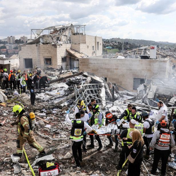 Emergency response teams attend the scene of a fatal Iranian strike, after Iran launched missile barrages following attacks by the U.S. and Israel on Saturday, in Beit Shemesh
