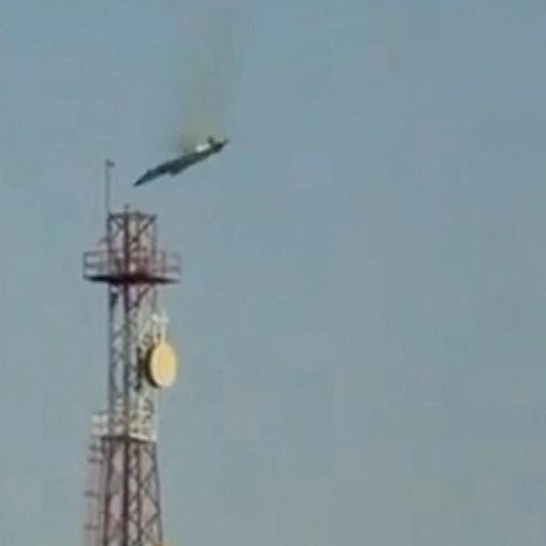 A burning aircraft falls from the sky in Al Jahra, in this still image obtained from social media video