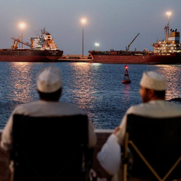 Galaxy Globe bulk carrier and Luojiashan tanker sit anchored in Muscat
