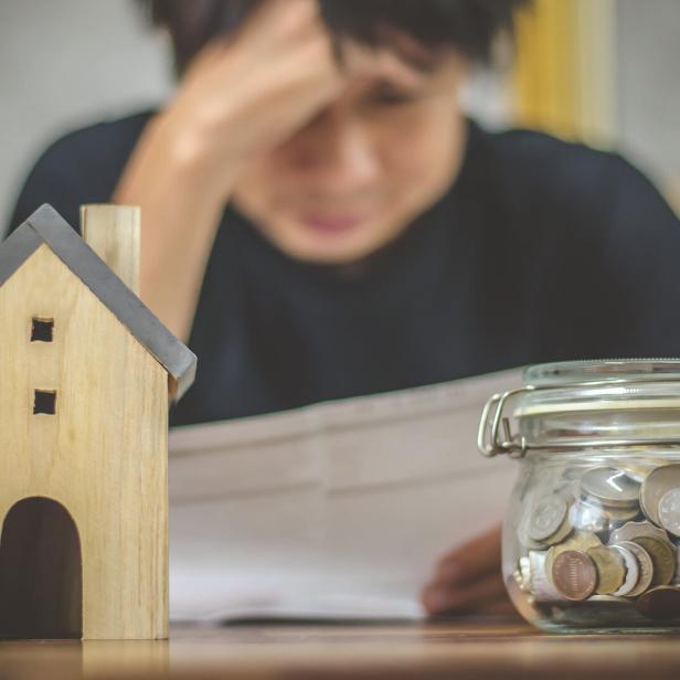 Young man checking bills and having financial problems with home debt, Money concept., real estate, buy an apartment