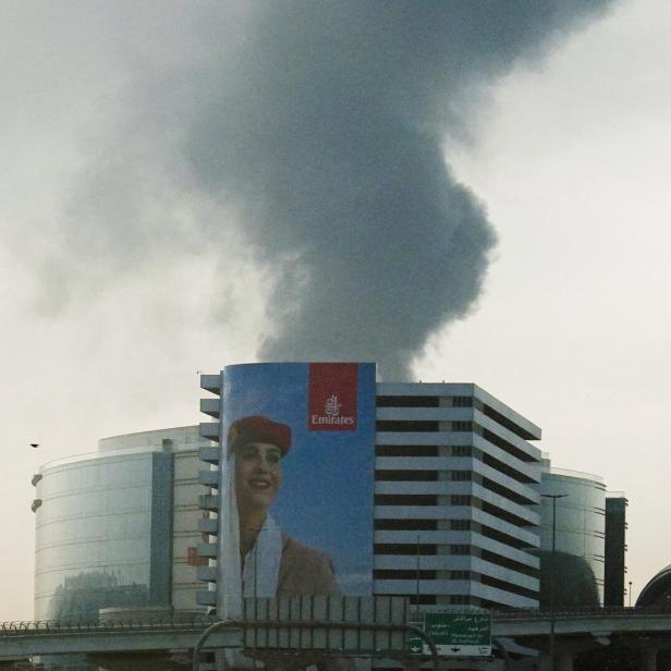 Smoke rises from the Dubai International Airport