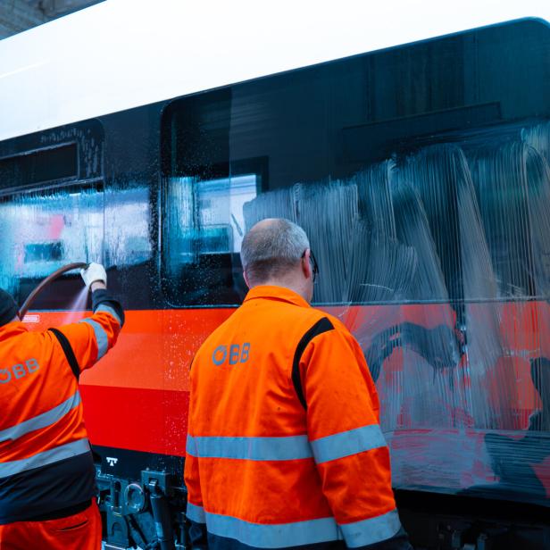 ÖBB-Personl entfernt Graffitis von Zug
