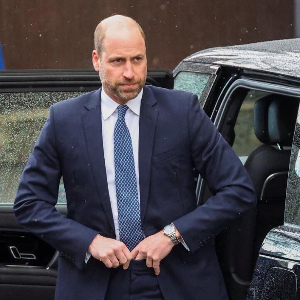 Prinz William steigt in einem dunklen Anzug und hellblauer Krawatte aus einem Auto.