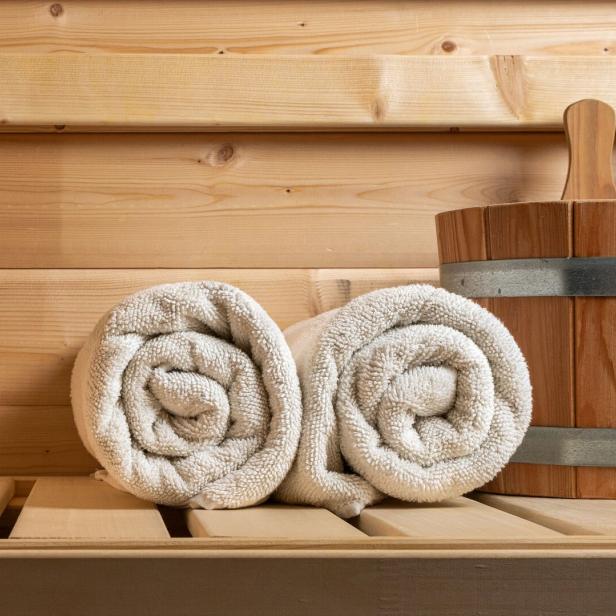 Detail from buckets and white towels in a sauna, wellness accessories