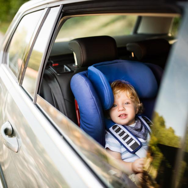 Little boy sitting in the car seat in the car.