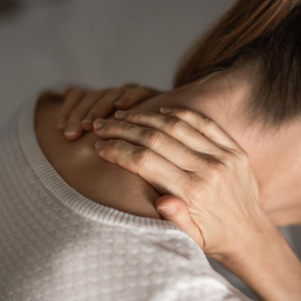 Woman holding her painful spine. Spine injury.