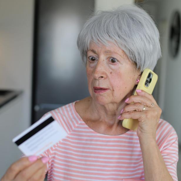 Skeptical looking senior woman during phone call