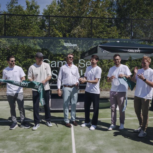 Acht Personen auf einem Padeltennis-Platz