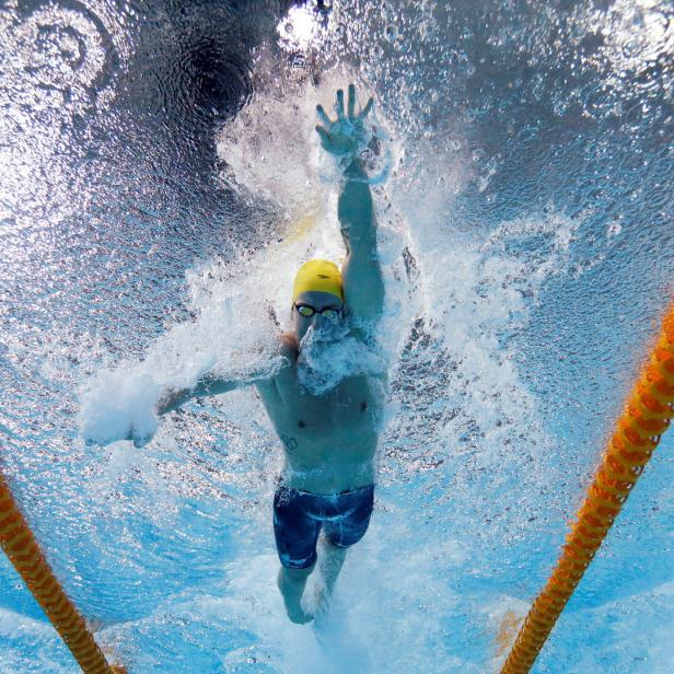 FILE PHOTO: Magnussen of Australia is seen underwater as he swims in the men's 100m Freestyle final during the 2014 Commonwealth Games in Glasgow
