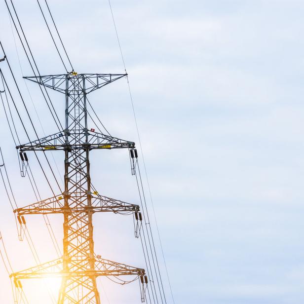 Electricity concept. Close up high voltage power lines station.