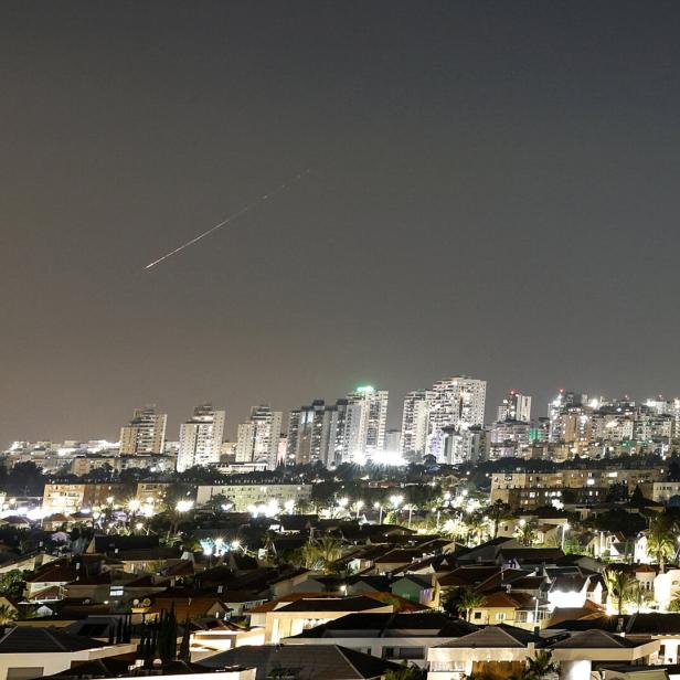 A streak of light illuminates the sky during Missile attack from Iran towards Israel as seen from Ashkelon