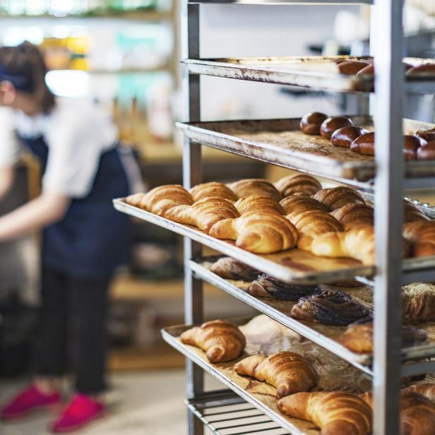 Fresh French Bread and croissants in a Bakery in cooling rack