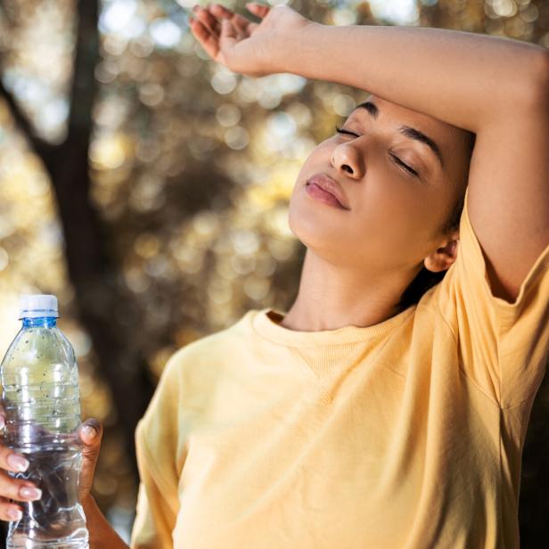 Young woman drinking water taking a break