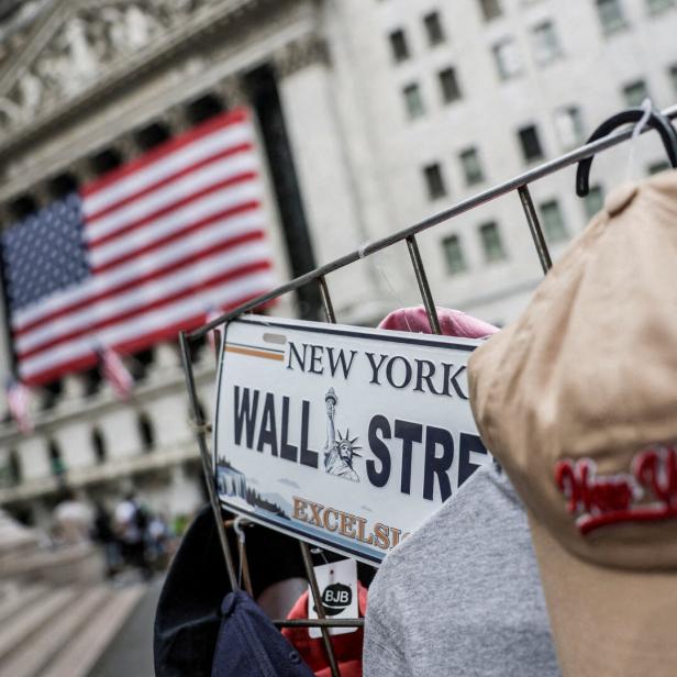 FILE PHOTO: A Wall Street plate is seen on a street vendor stall outside the New York Stock Exchange (NYSE) in New York City