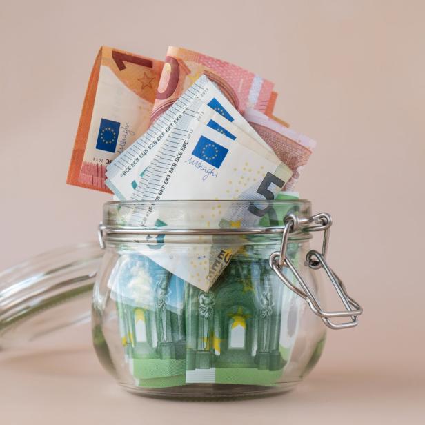 Euro cash banknote in glass jar on beige background. Saving money concept crisis and inflation Consumption and economy Collecting money. Tips. Extra money, passive