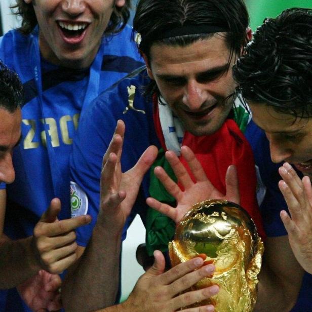 Italy players look at the World Cup Trophy after the World Cup 2006 final soccer match between Italy and France in Berlin