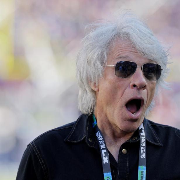Jon Bon Jovi mit Sonnenbrille und offenem Mund bei einem Gespräch während des Super Bowl LVIII.