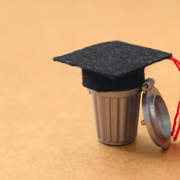 Devaluation of Academics: Mortarboard Discarded in Garbage Bin