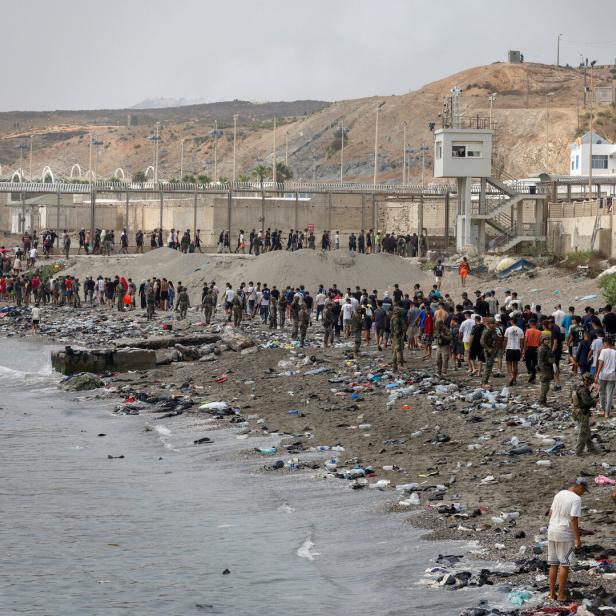 Migrants cross into the Spanish enclave of Ceuta
