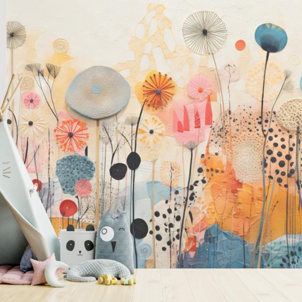 Bunt bedruckte Kinderzimmerwand mit Zelt, Kissen und Deko.
