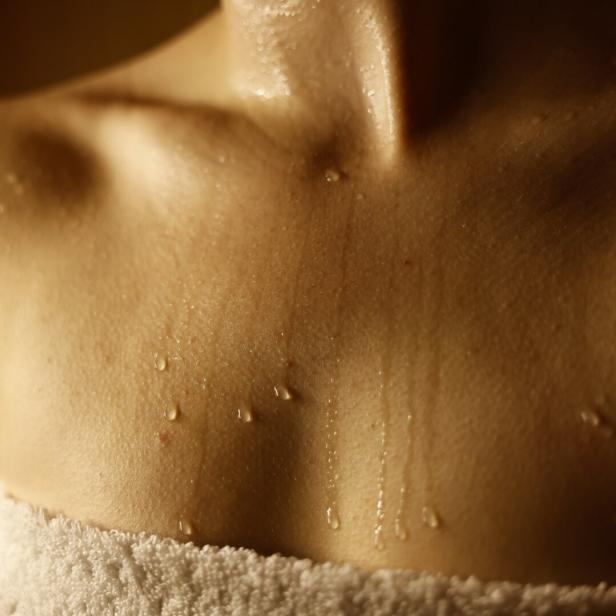 Young woman relaxing in hot sauna, closeup