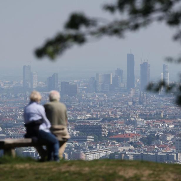 People enjoy a sunny spring day as they look down on the city of Vienna