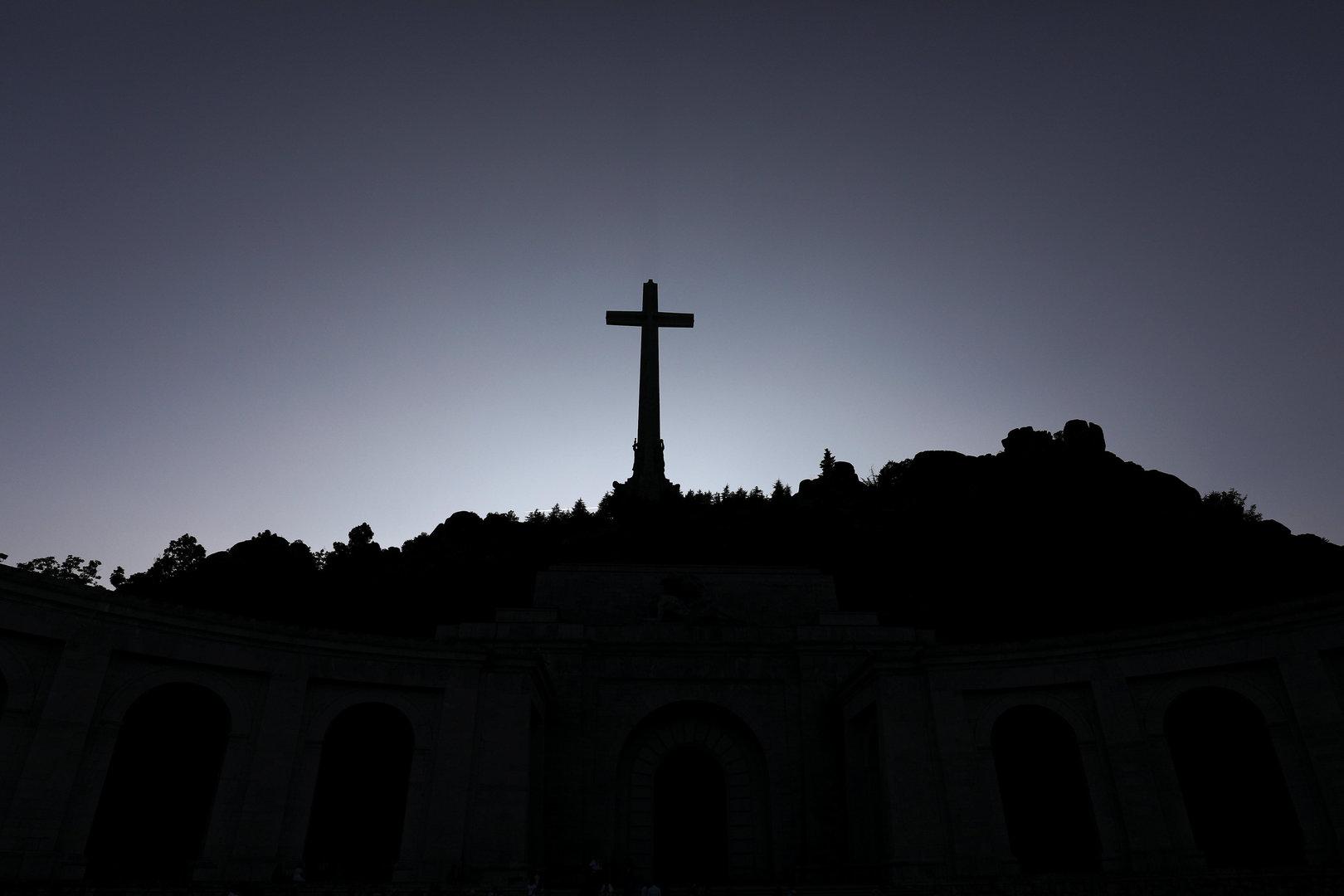 The 150-metre-high cross of the Valle de los Caidos (Valley of the Fallen) is seen over the giant mausoleum which houses the tomb of Spanish dictator Francisco Franco in San Lorenzo de El Escorial, outside Madrid