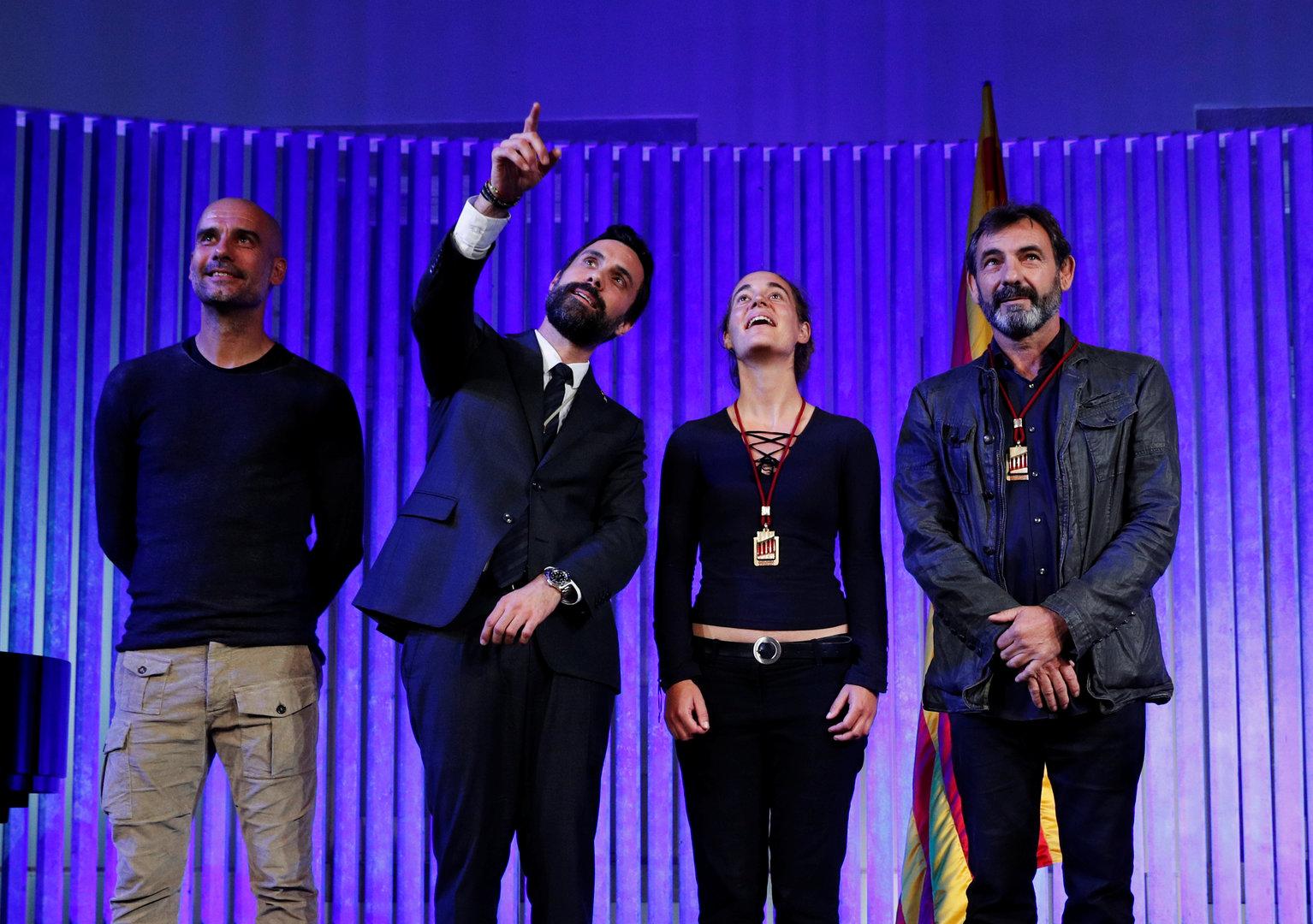 German captain of rescue ship Sea-Watch 3 Carola Rackete and Spanish NGO Proactiva Open Arms Oscar Camps pose with Catalonia's Parliament President Roger Torrent and soccer coach Pep Guardio