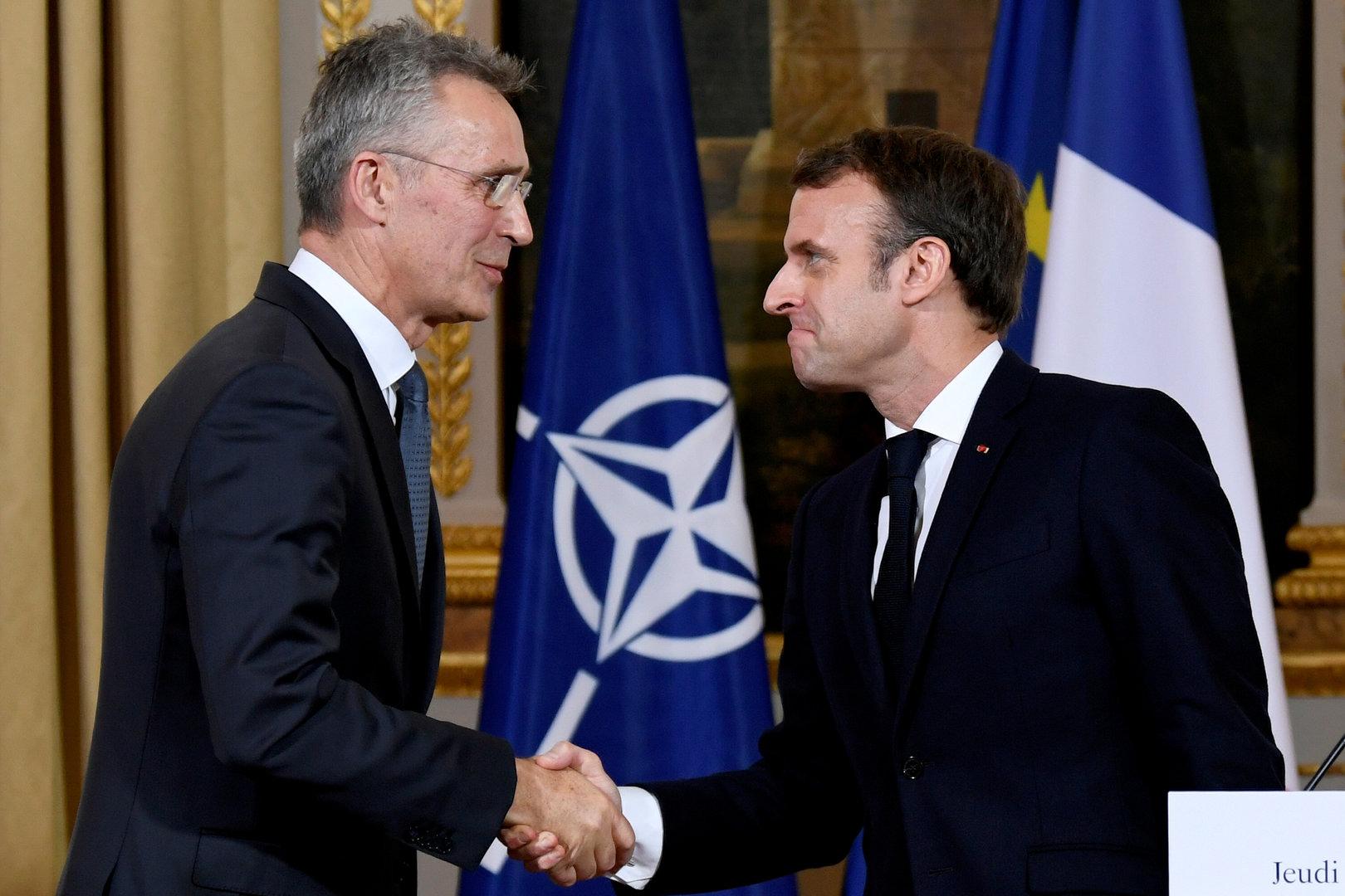 FILE PHOTO: NATO Secretary General Jens Stoltenberg and French President Emmanuel Macron shake hands at the end of a news conference after their meeting at the Elysee palace in Paris