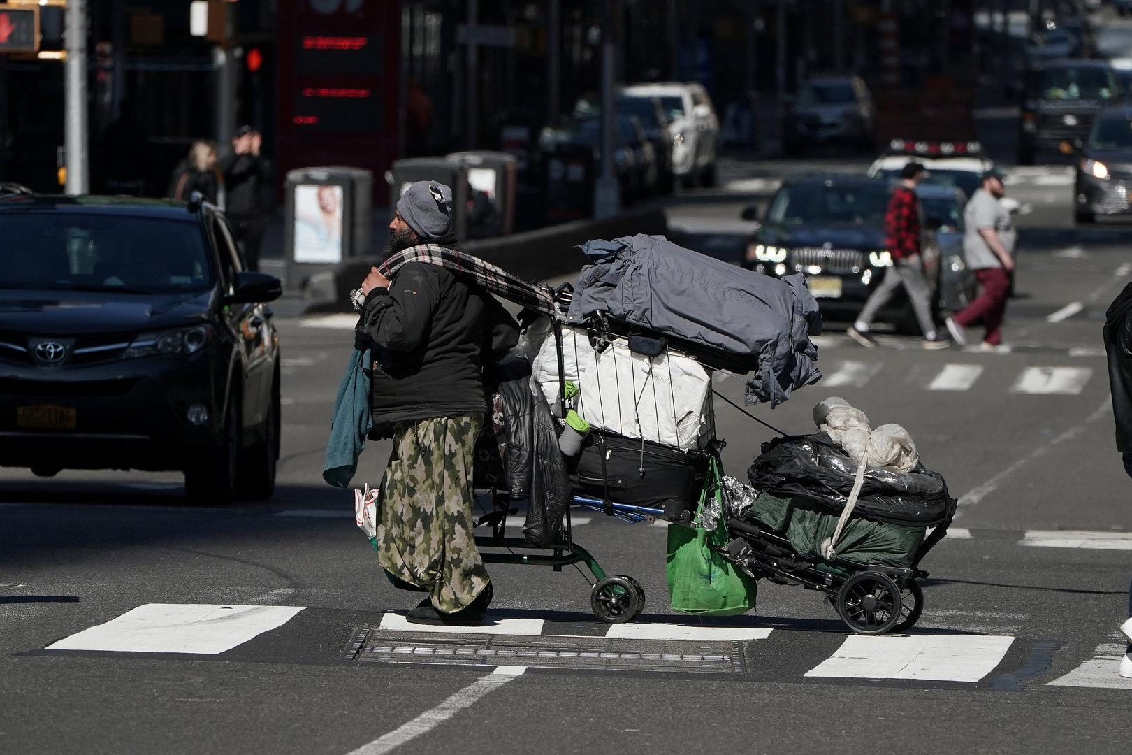 A homeless person crosses a deserted 7th Ave in Times Square during the outbreak of Coronavirus disease (COVID-19), in the Manhattan borough of New York City