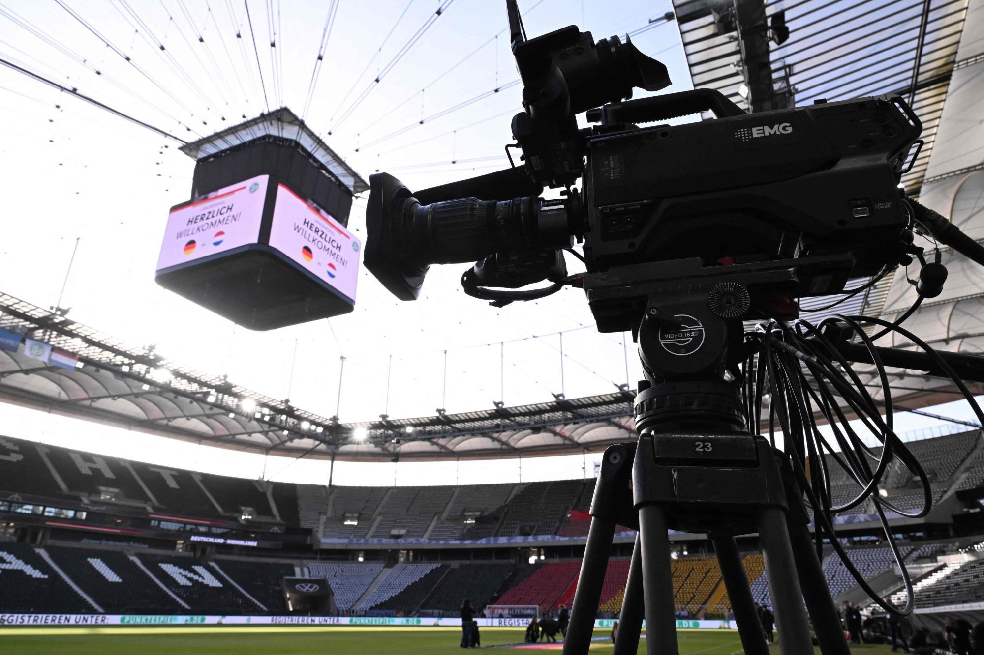 Eine EMG-Kamera filmt im Stadion, wo ein Bildschirm „Herzlich Willkommen!“ anzeigt.