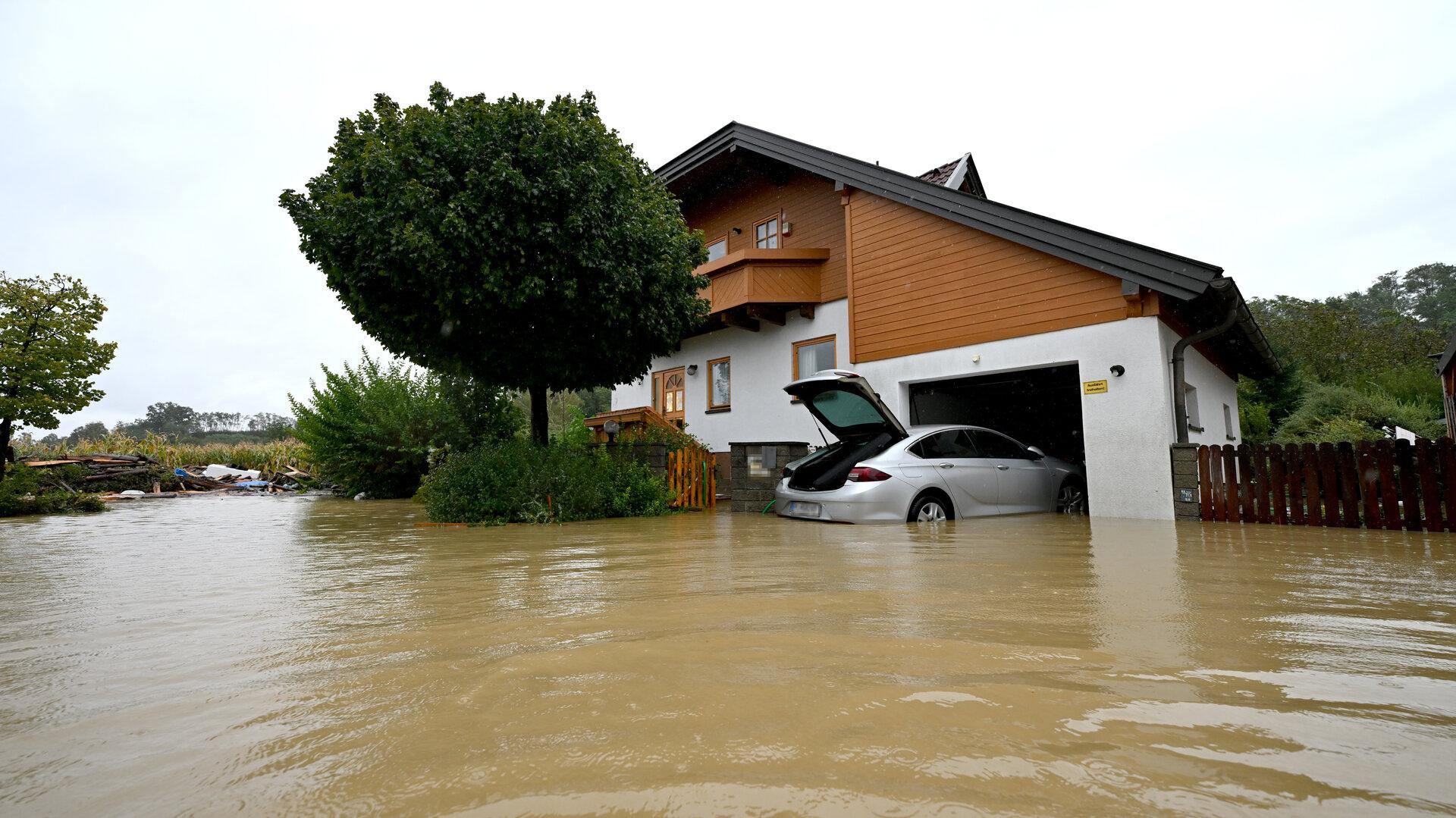 Ein Haus und ein Auto stehen im Hochwasser.