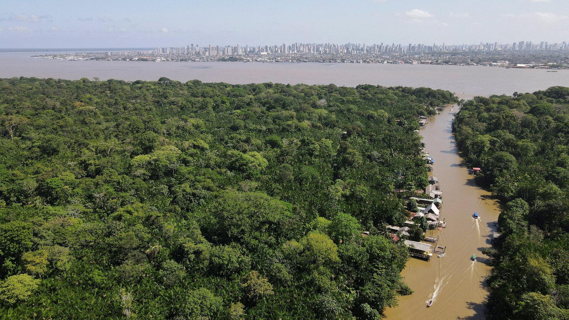 FILE PHOTO: A drone image shows the Amazon rainforest and the city of Belém in the back ahead of COP 30, at Ilha do Combu, in Belem